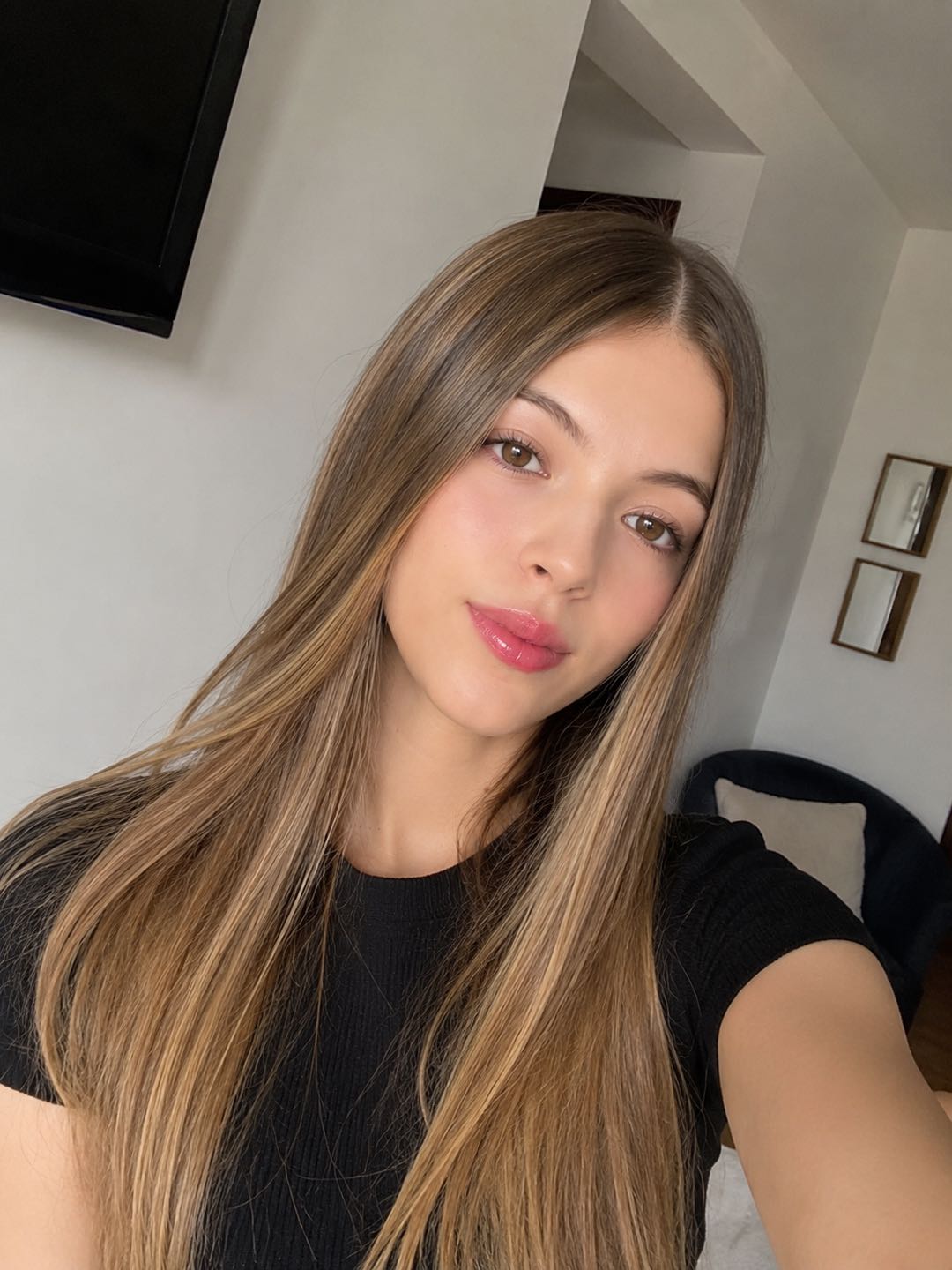 Woman at home looking into the camera before a video chat