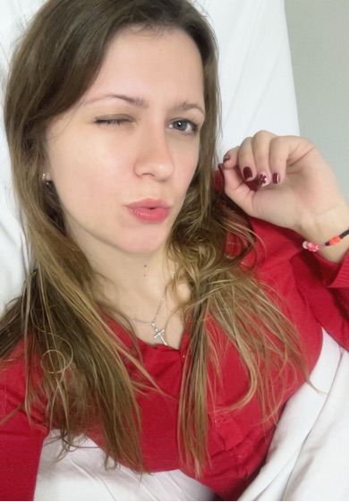 Woman winking playfully at the camera mid-conversation