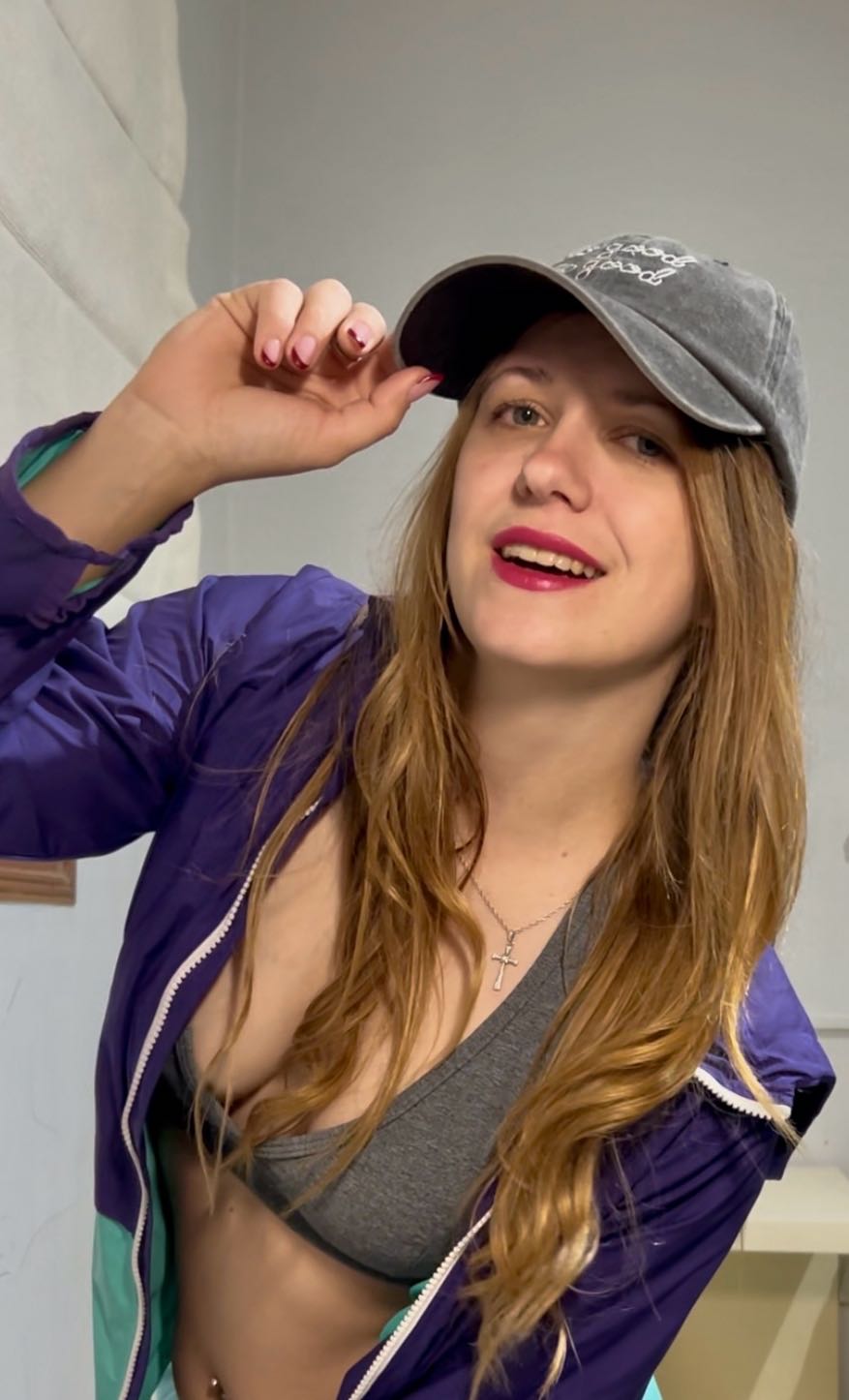 Woman in a cap and purple jacket whose profile might catch your attention